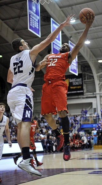 Nov 27, 2012; Evanston, IL, USA; Maryland Terrapins guard Dezmine Wells (32) is defended by Northwestern Wildcats center Alex Olah (22) during the first half at Welsh-Ryan Arena. Mandatory Credit: David Banks-US PRESSWIRE