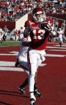 Nov 10, 2012; Bloomington, IN, USA; Indiana Hoosiers wide receiver Kofi Hughes (13) catches a touchdown pass in the end zone against Wisconsin Badgers defensive back Marcus Cromartie (14) at Memorial Stadium. Wisconsin defeats Indiana 62-14. Mandatory Credit: Brian Spurlock-US PRESSWIRE