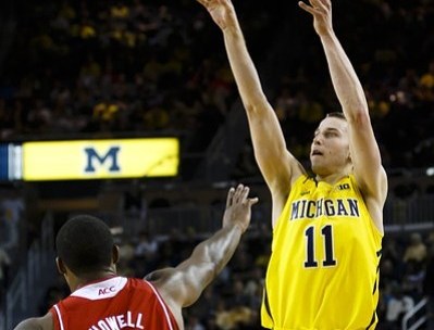 November 27, 2012; Ann Arbor, MI, USA; Michigan Wolverines guard Nik Stauskas (11) shoots the ball over North Carolina State Wolfpack forward Richard Howell (1) in the first half at Crisler Center. Mandatory Credit: Rick Osentoski-US PRESSWIRE