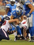 November 22, 2012; Detroit, MI, USA; Houston Texans defensive end J.J. Watt (99) tries to strip ball from Detroit Lions quarterback Matthew Stafford (9) during the second half of a game on Thanksgiving at Ford Field. The Texans won 34-31. Mandatory Credit: Mike Carter-US PRESSWIRE