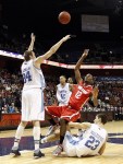 Nov 17, 2012; Uncasville, CT, USA; Ohio State Buckeyes forward Sam Thompson (12) shoots the ball against Rhode Island Rams forward Mike Aaman (34) and forward Nikola Malesevic (23) during the first half at Mohegan Sun Arena. Mandatory Credit: Mark L. Baer-US PRESSWIRE