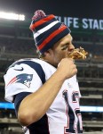 Nov. 22, 2012; East Rutherford, NJ, USA; New England Patriots quarterback Tom Brady (12) takes a bite out of a turkey leg after the game against the New York Jets on Thanksgiving at Metlife Stadium. Patriots won 49-19. Mandatory Credit: Debby Wong-US PRESSWIRE