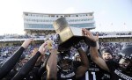 Nov 24, 2011; Evanston, IL, USA; Members of the Northwestern Wildcats raise the Land of Lincoln trophy after beating the Illinois Fighting Illini at Ryan Field. the Northwestern Wildcats defeated the Illinois Fighting Illini 50-14. Mandatory Credit: David Banks-US PRESSWIRE