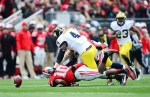Nov 24, 2012; Columbus, OH, USA; Michigan Wolverines linebacker Cameron Gordon (4) jumps on a muffed punt by Ohio State Buckeyes wide receiver Philly Brown (10) in the second quarter at Ohio Stadium. Mandatory Credit: Andrew Weber-US PRESSWIRE