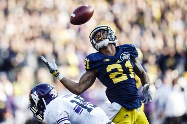 November 10, 2012; Ann Arbor, MI, USA; Michigan Wolverines wide receiver Roy Roundtree (21) makes a reception for fifty three yards to set up a game tying field goal against the Northwestern Wildcats in the fourth quarter at Michigan Stadium. Mandatory Credit: Rick Osentoski-US PRESSWIRE