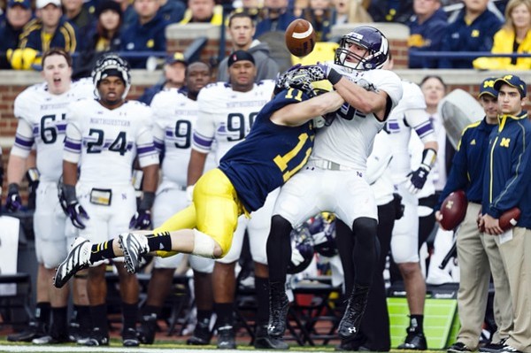 November 10, 2012; Ann Arbor, MI, USA; Michigan Wolverines safety Jordan Kovacs (11) hits Northwestern Wildcats tight end Dan Vitale (40) to knock the ball loose for an incomplete pass in the fourth quarter at Michigan Stadium. Michigan won 38-31 in overtime. Mandatory Credit: Rick Osentoski-US PRESSWIRE