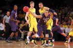 November 23, 2012; New York, NY, USA; Kansas State Wildcats guard Angel Rodriguez (13) loses the ball while being defended by Michigan Wolverines guard Matt Vogrich (13) and forward Jordan Morgan (52) during the first half of the NIT Season Tip-Off championship game at Madison Square Garden.