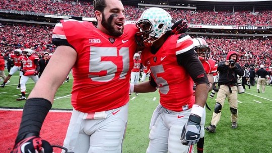 Nov 24, 2012; Columbus, OH, USA; Ohio State Buckeyes defensive tackle Joel Hale (51) celebrates with teammate Braxton Miller (5) after defeating the Michigan Wolverines 26-21 to go undefeated on the season at Ohio Stadium. Mandatory Credit: Andrew Weber-US PRESSWIRE.Credit: US PRESSWIRE