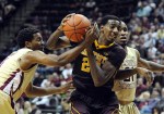 Nov 27, 2012; Tallahassee, FL, USA; Minnesota Golden Gophers guard Austin Hollins (20) is fouled by Florida State Seminoles guard Devon Bookert (1) during the game at the Donald L. Tucker Center. Mandatory Credit: Melina Vastola-US PRESSWIRE