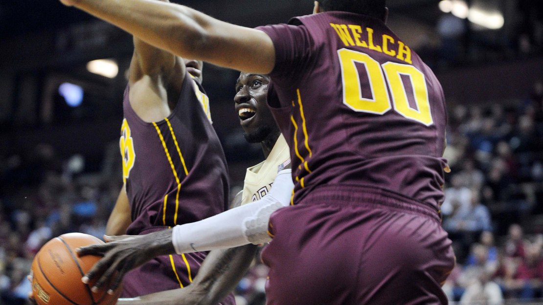 Nov 27, 2012; Tallahassee, FL, USA; Florida State Seminoles forward Okaro White (10) tries to shoot the ball as he is defended by Minnesota Golden Gophers guard Julian Welch (00) during the game at the Donald L. Tucker Center. Mandatory Credit: Melina Vastola-US PRESSWIRE