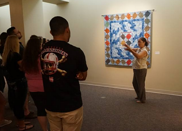 Westerman tells students from a Nebraska women and gender studies class about her artwork.