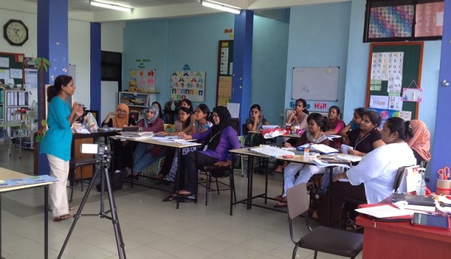 Muttiah (standing) helps train special ed teachers in Sri Lanka.