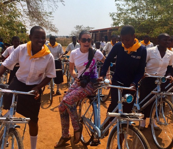 Bohn (center) with grateful recipients of bicycles distributed through SchoolCycle, the charity organization she started with Fox.