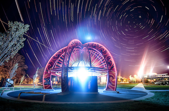 The Visiting Our Solar System (VOSS) sculpture as seen at night with a combination of high dynamic range (HDR) and a long exposure to capture the star trails over Purdue. The $1.5 million student-led interactive exhibit puts the size of space in perspective and celebrates the contributions of the late alumna and NASA astronaut Janice Voss. This photo was shot for Purdue Alumnus Magazine. (Photo courtesy of Purdue University and Charles Jischke Photography.)