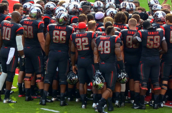 Members of the Rutgers football team show that they are family.