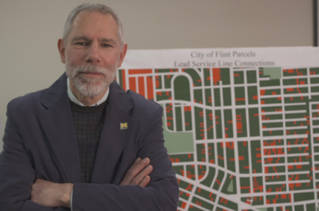 Prof. Kaufman with the map of Flint with water lines containing lead uncovered so far.