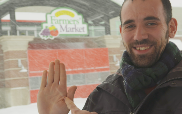 Prof. Sadler in front of the Flint Farmers' Market.