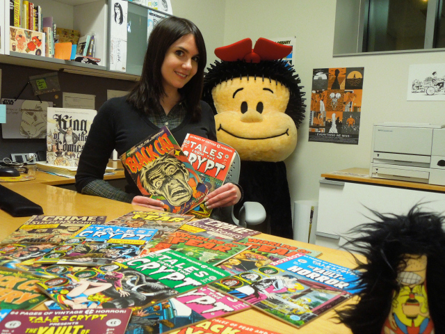 Caitlin McGurk, visiting curator of The Ohio State University's Billy Ireland Cartoon Library and Museum poses with collection