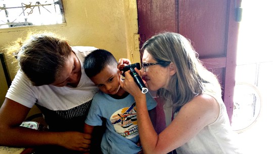 University of Nebraska audiologist Stacie Ray seeing a young patient in Nicaragua