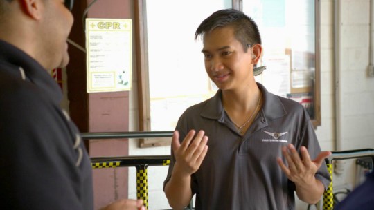Raymart Tinio, a student of the Able Flight program at Purdue University, converses via sign language with an instructor.