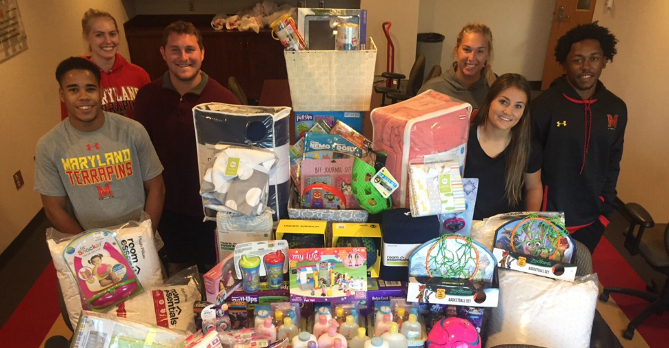 Student-athletes with the University of Maryland's Share the Shell program collect items for women's shelters.