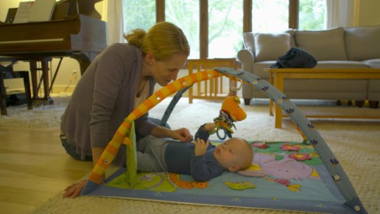 University of Wisconsin researcher Dr. Katie Brenner plays with her baby.
