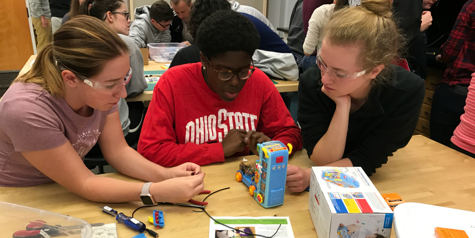 Students at the Ohio State University TAPS program work on modifying a toy.