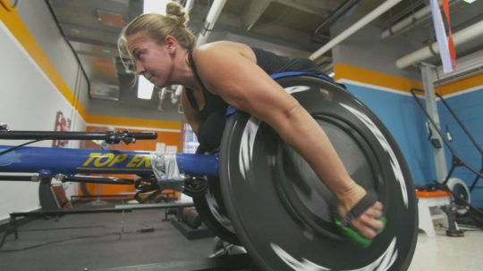 University of Illinois wheelchair racer Arielle Rausin tests out her 3D-printed racing gloves.