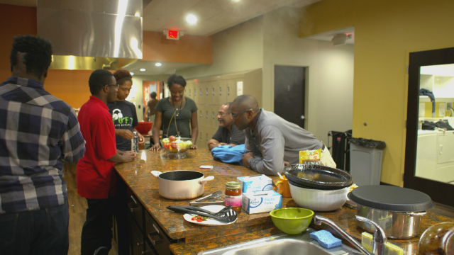 Homeless youth and staff prepare a meal in the kitchen of Ohio State's Star House