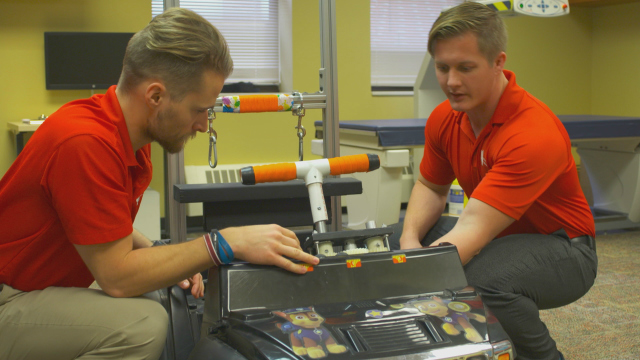 GoBabyGo@IU co-founders Michael Mohr and Andrew Wiseman working on a modified car.