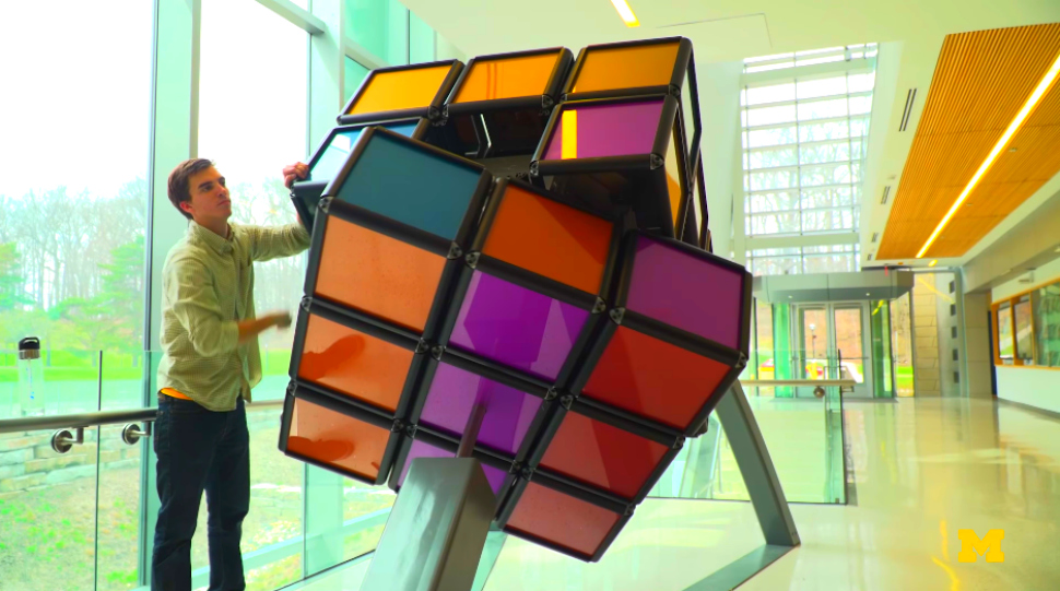University of Michigan engineering student puts the finishing touches on the Rubik's Cube sculpture.