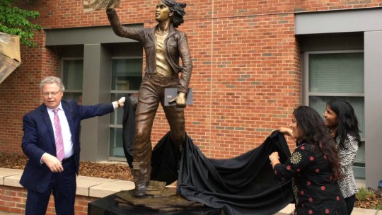 College of Engineering dean Andreas Cangellaris and student Sakshi Srivastava unveil the University of Illinois' newest statue, The Quintessential engineer.