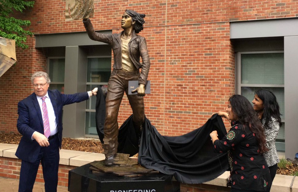 College of Engineering dean Andreas Cangellaris and student Sakshi Srivastava unveil the University of Illinois' newest statue, The Quintessential engineer.