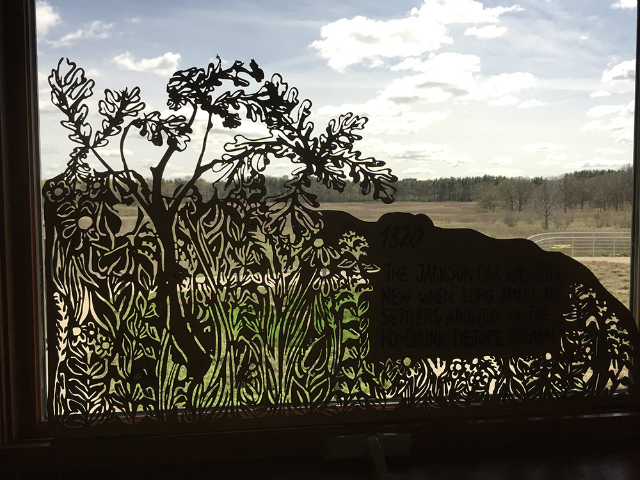 A laser-etched sign from University of Wisconsin artist Liz Anna Kozik's prairie exhibit.