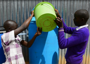 Students easily add water to their school's slow sand filter.