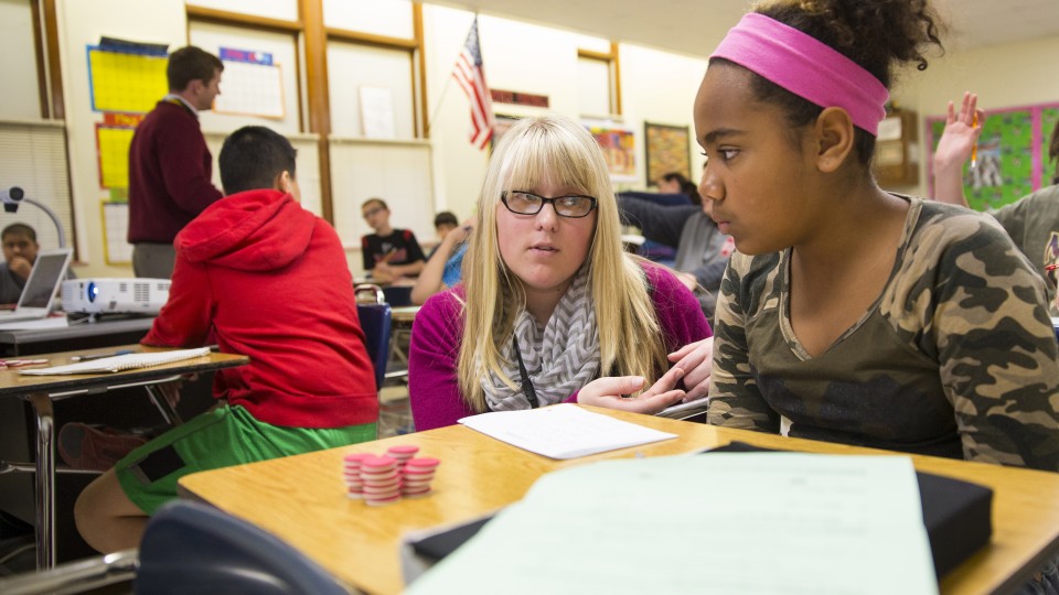 Megan Jorgensen, a University of Nebraska-Lincoln graduate, discusses a STEM problem with a student at Lincoln's Park Middle School in this file photo from 2014.
