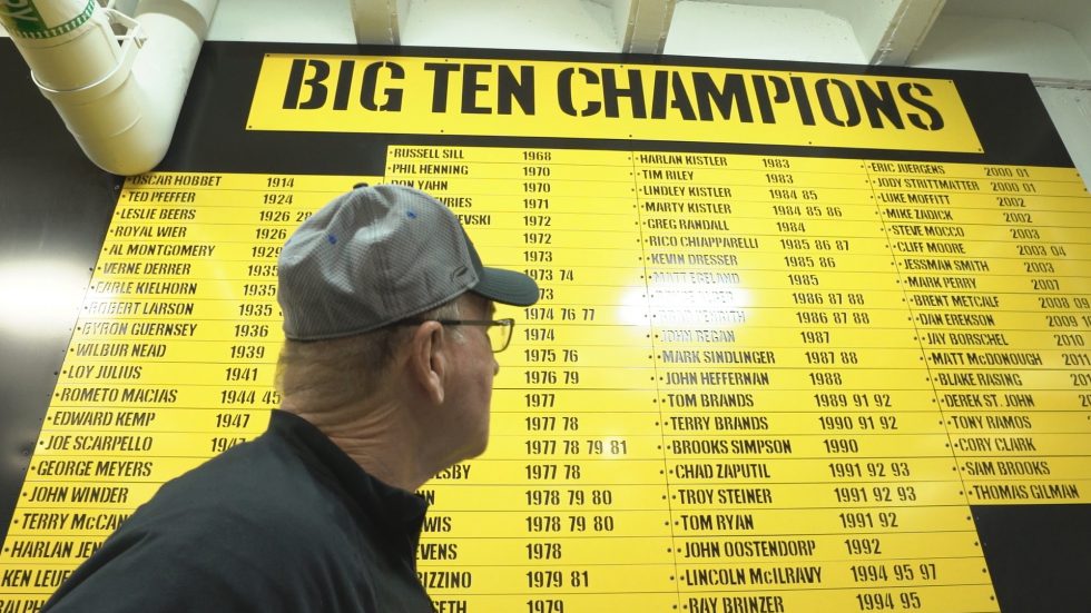Famed University of Iowa wrestling coach Dan Gable looks at a board naming all of his Big Ten Champions
