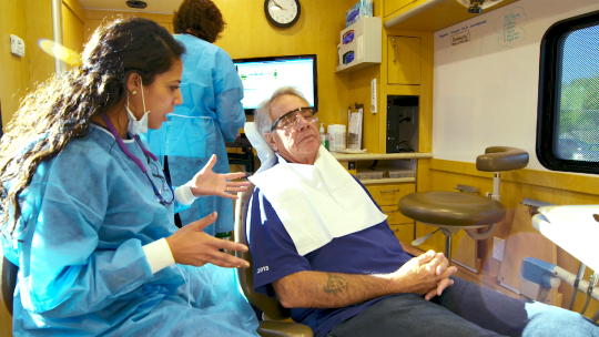 University of Minnesota dental student seeing a patient in the UCare Mobile Dental Clinic