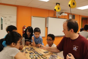 University of Illinois alum Daniel Zaharopol plays a math game with students in the BEAM program