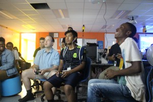 University of Illinois alum Daniel Zaharopol plays videogames with students in the BEAM program. 