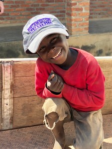 A child in Malawi wearing a Northwestern University basketball cap.