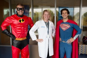 Penn State doctor Amy burns with medical students and members of the BraveCubs program dressed as superheroes Mr. Incredible and Superman