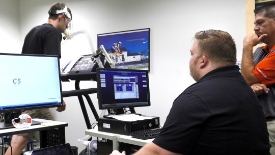 an ohio state university esports athlete is hooked up to a machine on a treadmill in a lab for study