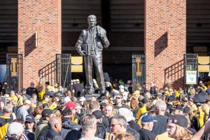 University of Iowa fans pass Nile Kinnick's statue as they enter Kinnick Stadium.