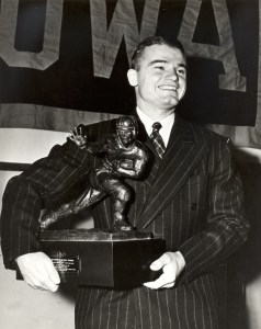 University of Iowa great Nile Kinnick poses with his 1939 Heisman Trophy