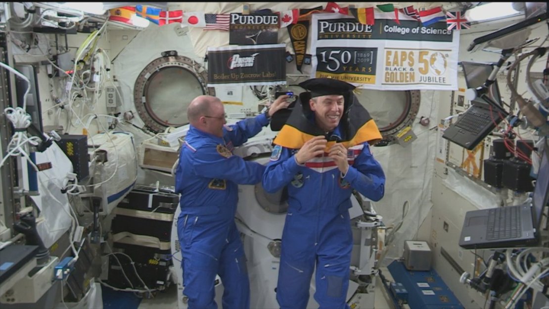 Purdue university alum and astronaut Andrew Feustel being awarded an honorary doctorate aboard the International Space station and being hooded by fellow boilermaker astronaut Scott Tingle